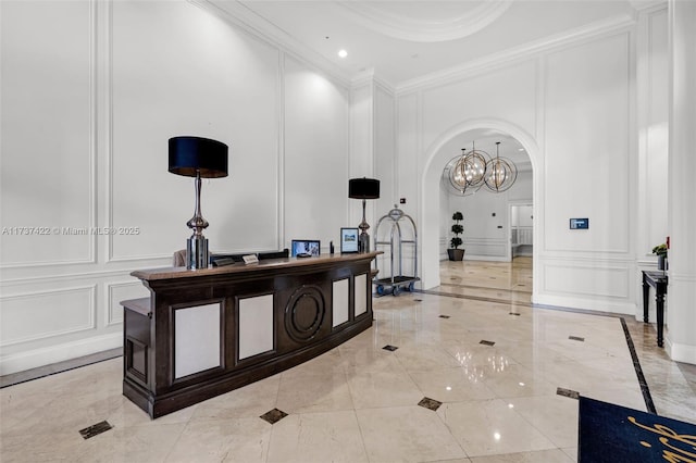 55 Merrick Way Unit 624, Coral Gables, FL 33134 - hallway featuring a decorative wall, arched walkways, light marble finish flooring, and crown molding
