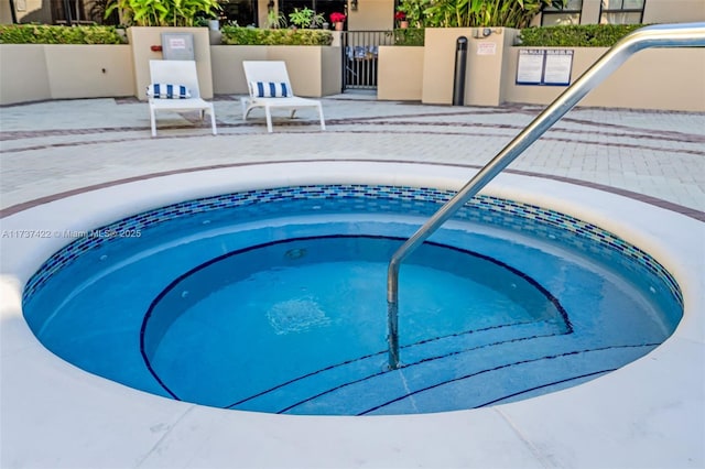 view of swimming pool with a community hot tub and a patio