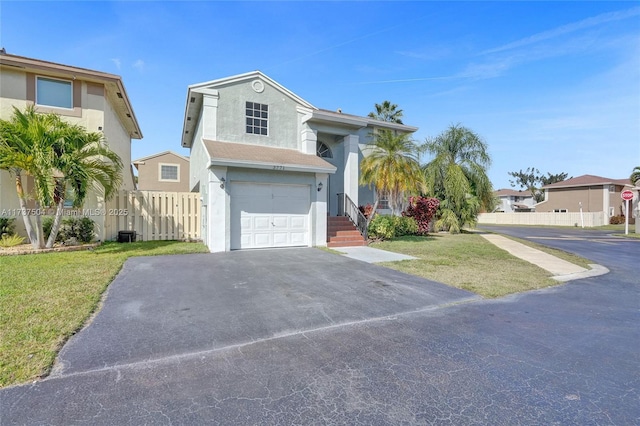 view of front facade with a garage and a front yard