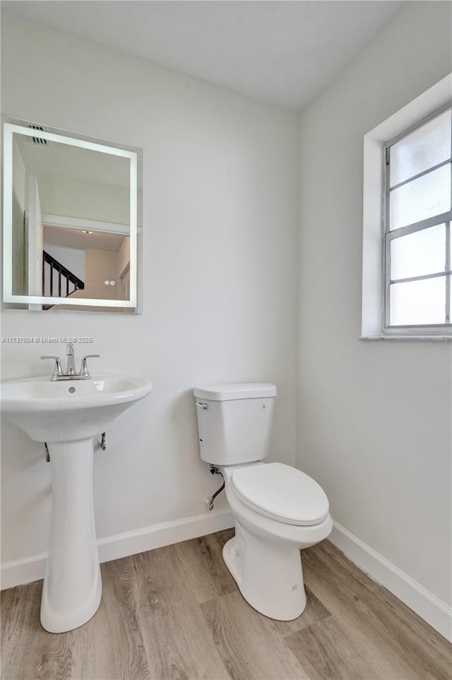 bathroom featuring sink, hardwood / wood-style floors, and toilet