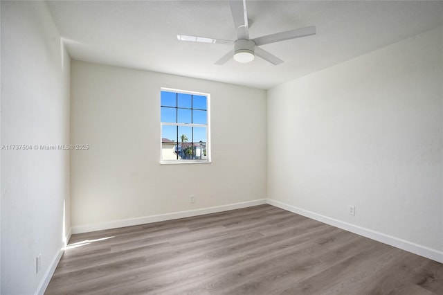 unfurnished room with hardwood / wood-style flooring and ceiling fan