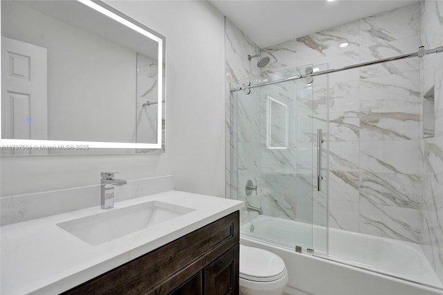 full bathroom with vanity, shower / bath combination with glass door, and toilet