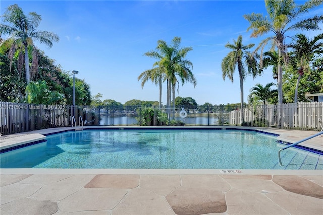 view of swimming pool featuring a water view