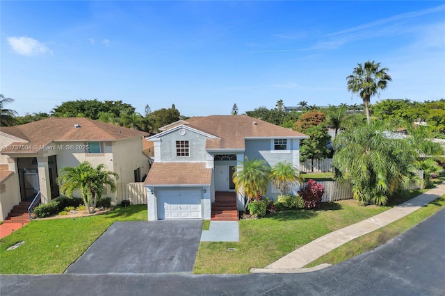 view of front of property with a garage and a front lawn