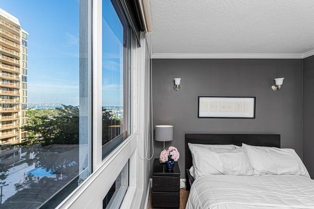 bedroom with crown molding and a textured ceiling