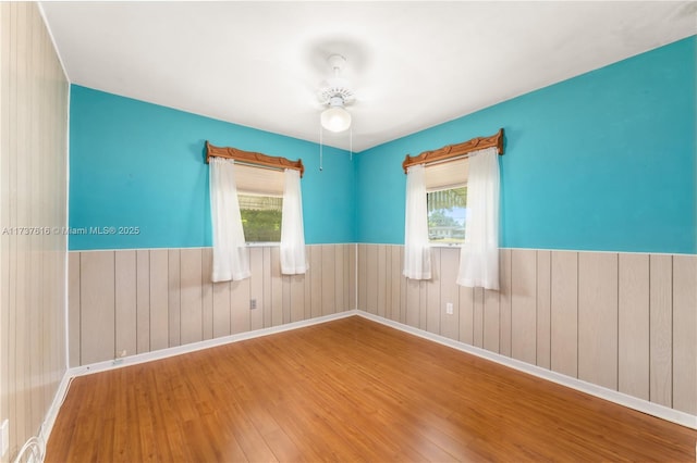 spare room featuring hardwood / wood-style floors and a wealth of natural light