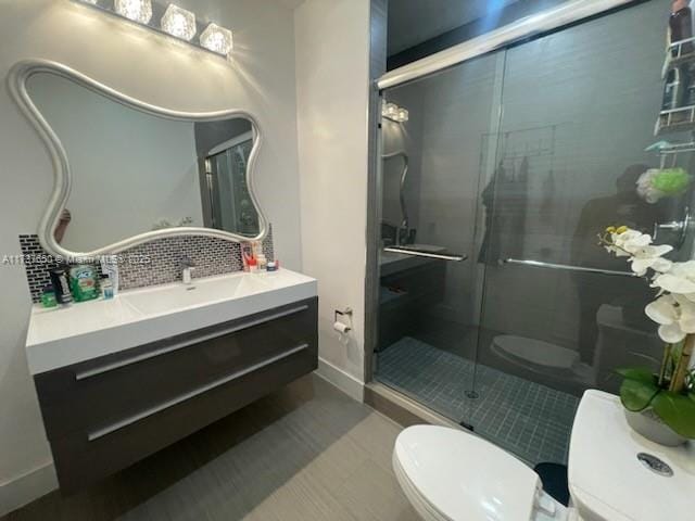 10290 SW 7th Ter, Sweetwater, FL 33174 - bathroom featuring vanity, baseboards, a stall shower, toilet, and backsplash