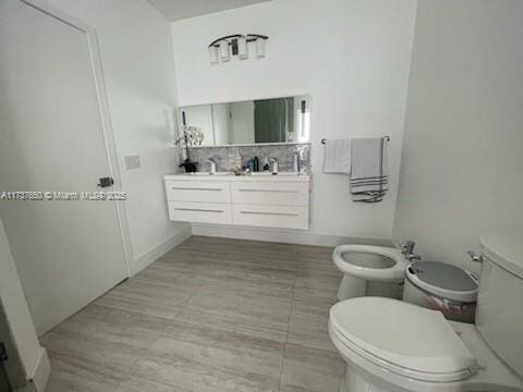 10290 SW 7th Ter, Sweetwater, FL 33174 - bathroom featuring decorative backsplash, a bidet, toilet, and vanity