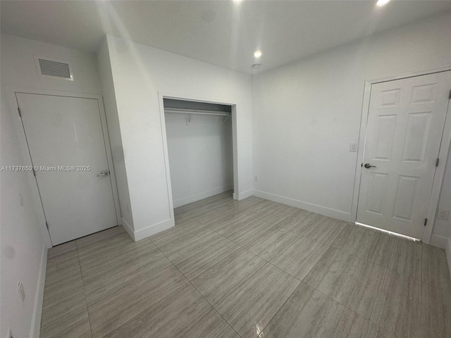 10290 SW 7th Ter, Sweetwater, FL 33174 - unfurnished bedroom with a closet, baseboards, and light tile patterned floors