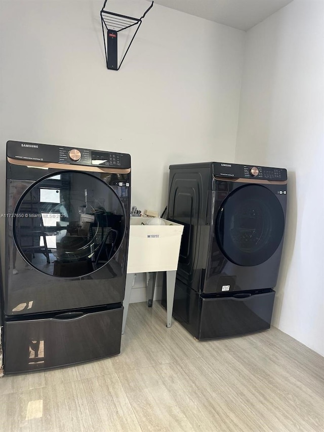 10290 SW 7th Ter, Sweetwater, FL 33174 - washroom featuring wood finished floors and washer and clothes dryer