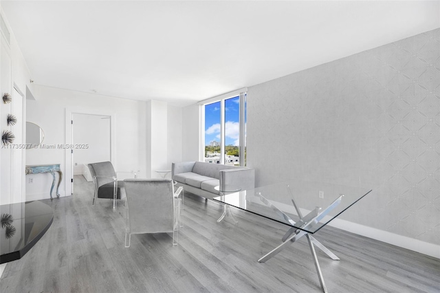 living room featuring expansive windows and light hardwood / wood-style floors