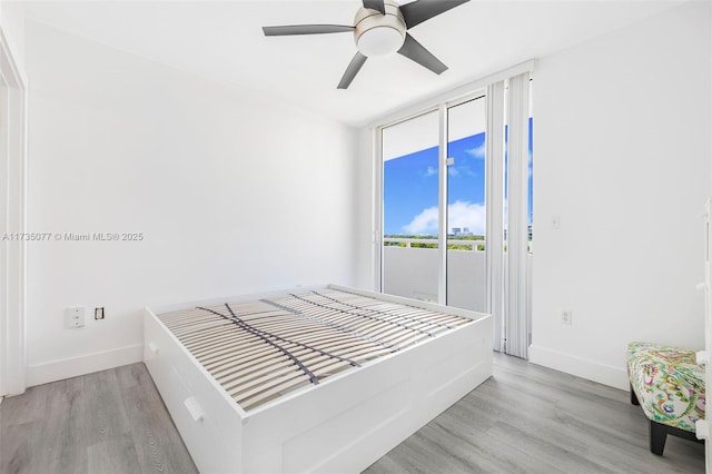 bedroom with access to exterior, ceiling fan, and light wood-type flooring