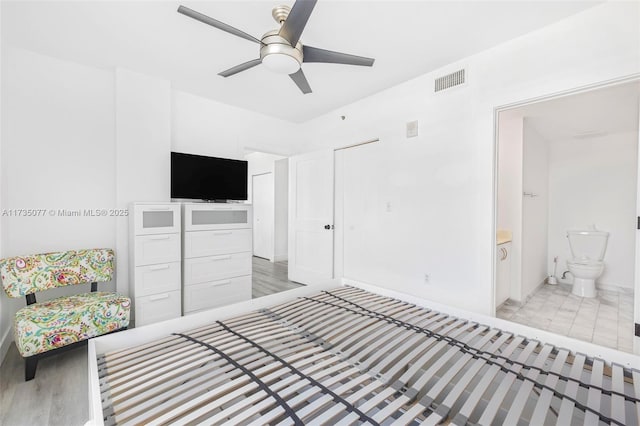 bedroom with ceiling fan and ensuite bath