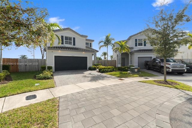 view of front of property with a garage and a front lawn