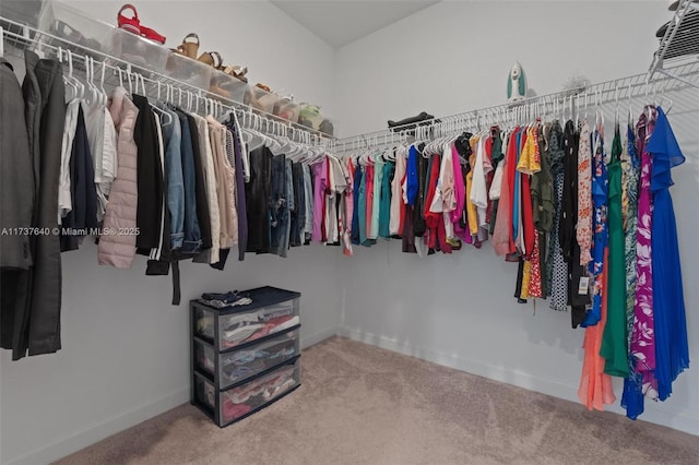 walk in closet with carpet