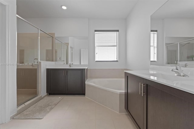 bathroom featuring vanity, independent shower and bath, and tile patterned flooring