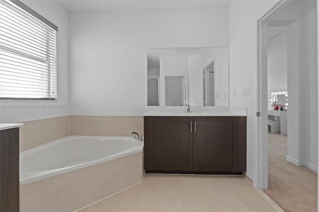 bathroom with vanity and tiled bath