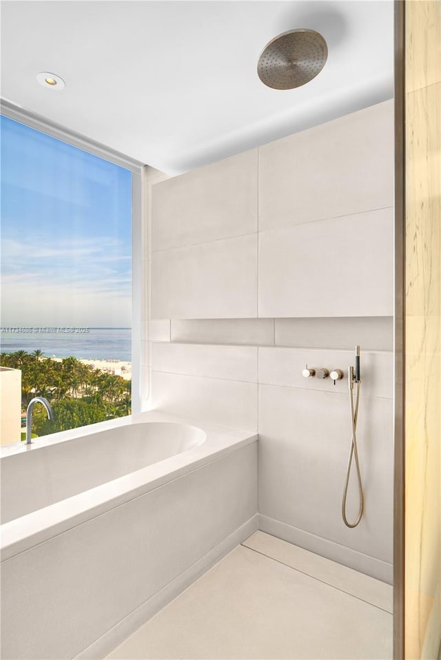 bathroom with a water view and independent shower and bath