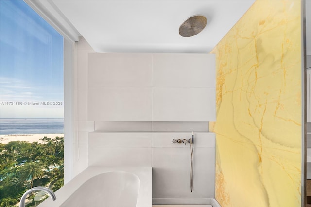 bathroom featuring a water view and a washtub