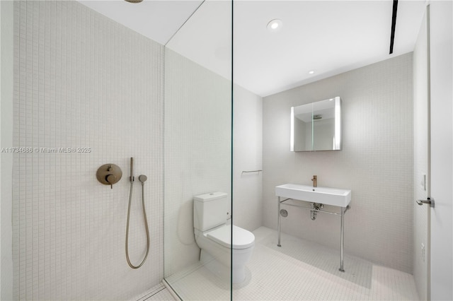 bathroom with tile patterned flooring, sink, toilet, and walk in shower