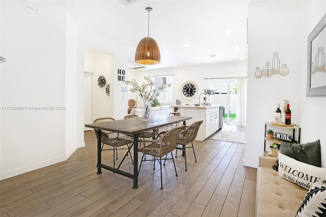 dining room with sink and light hardwood / wood-style floors