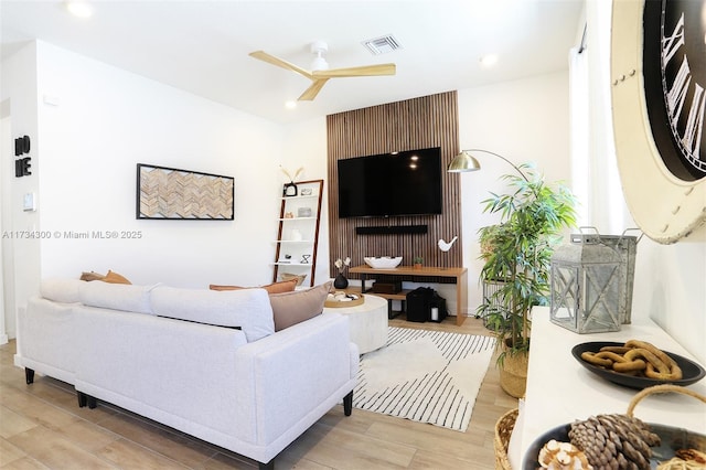 living room featuring ceiling fan and light wood-type flooring