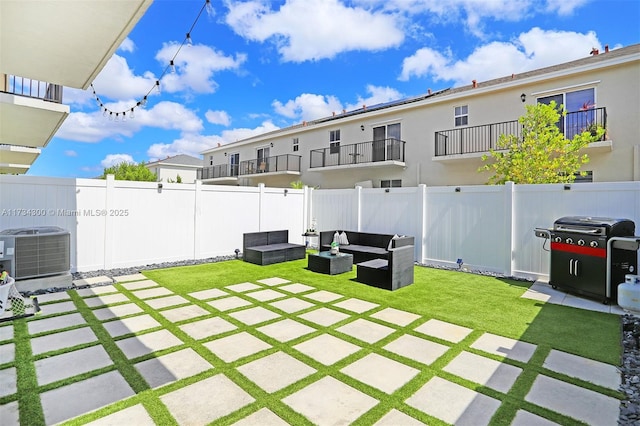 view of yard featuring an outdoor living space, a patio area, and central air condition unit