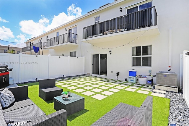 rear view of property featuring an outdoor living space, central AC, and a patio