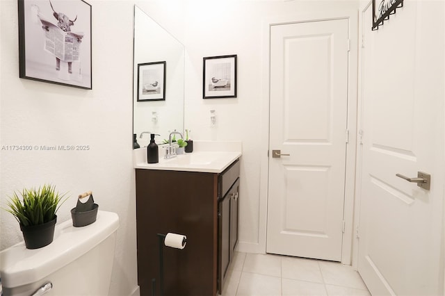 bathroom featuring tile patterned floors, toilet, and vanity