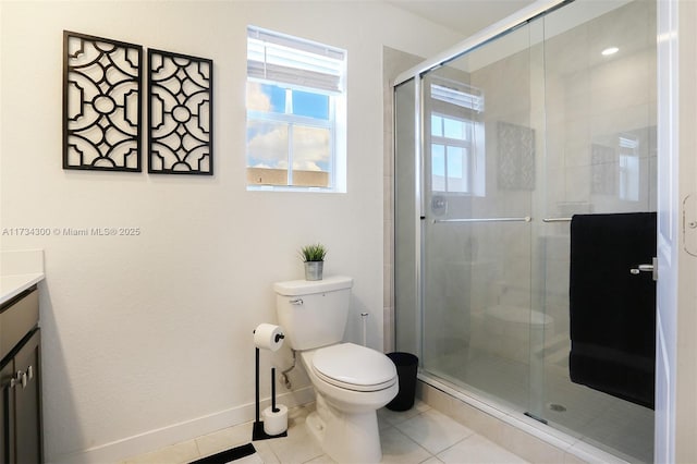 bathroom with tile patterned floors, toilet, an enclosed shower, and vanity