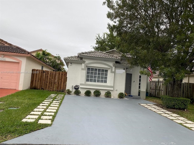 view of front of house featuring a garage and a front lawn