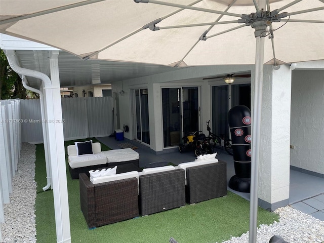 view of patio / terrace featuring ceiling fan and an outdoor living space