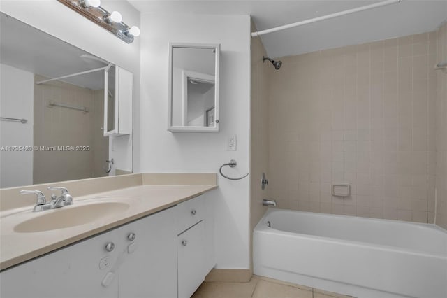 bathroom featuring tiled shower / bath combo, vanity, and tile patterned floors