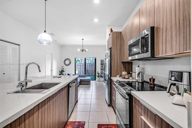 kitchen with decorative light fixtures, sink, light tile patterned floors, a notable chandelier, and stainless steel appliances