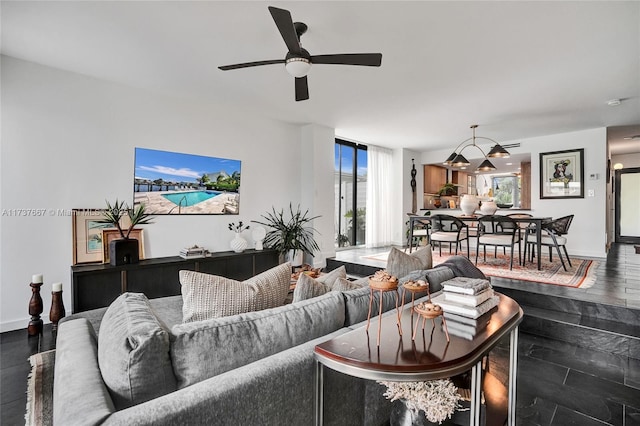 living room with dark hardwood / wood-style flooring and ceiling fan