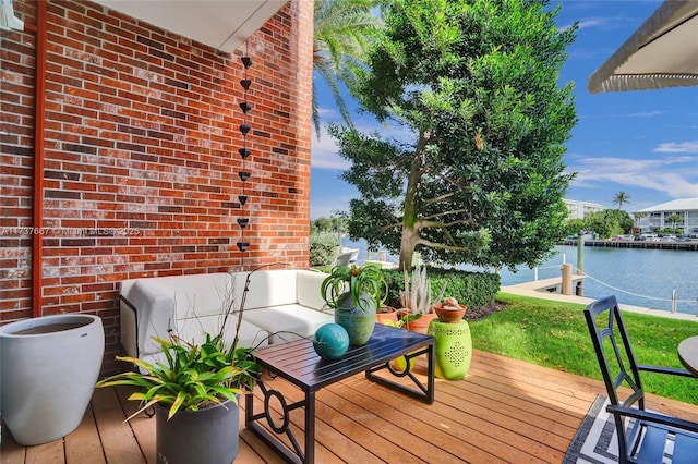 wooden terrace featuring a water view