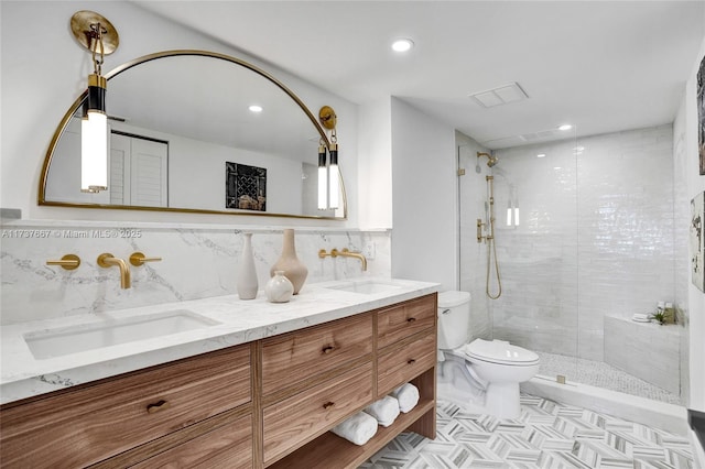 bathroom with vanity, a tile shower, backsplash, and toilet