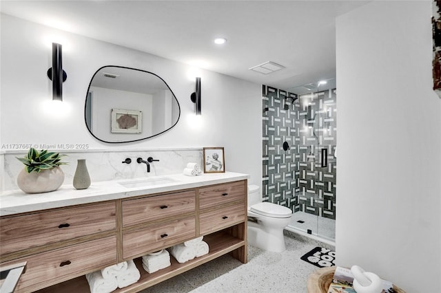 bathroom featuring decorative backsplash, vanity, an enclosed shower, and toilet