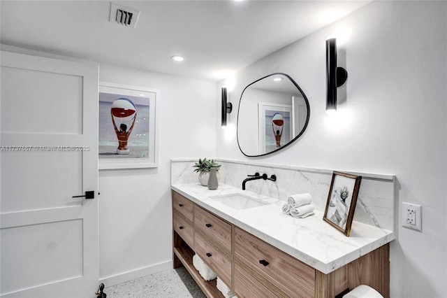 bathroom with vanity and backsplash