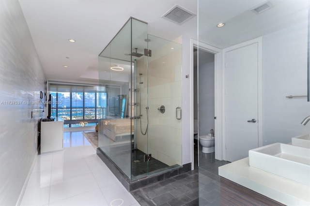 bathroom featuring tile patterned floors, a shower with shower door, and vanity