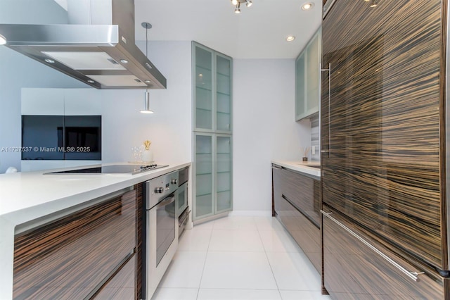 kitchen with pendant lighting, light tile patterned floors, black electric stovetop, island exhaust hood, and stainless steel oven