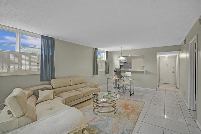 living room featuring a textured ceiling and light tile patterned floors