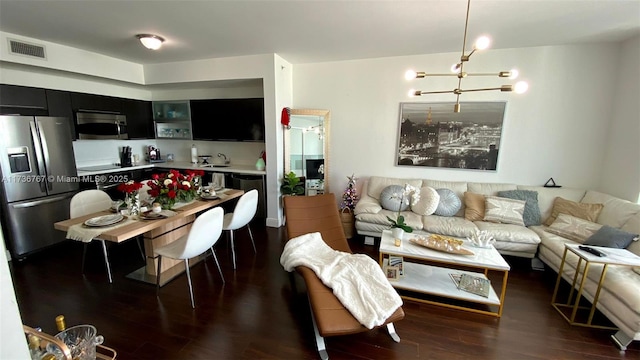 living room with dark hardwood / wood-style flooring, sink, and a chandelier