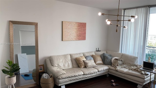 living room with an inviting chandelier and hardwood / wood-style flooring