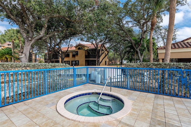 view of swimming pool with an in ground hot tub and a patio area