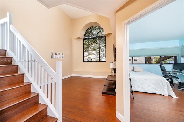 stairs featuring hardwood / wood-style flooring and a wealth of natural light