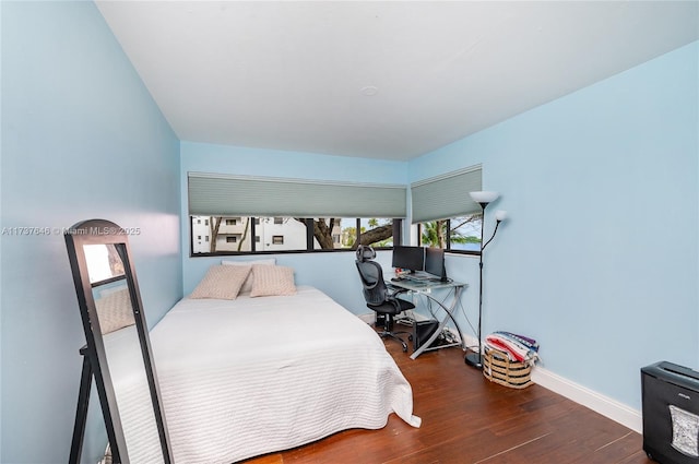 bedroom featuring dark hardwood / wood-style flooring