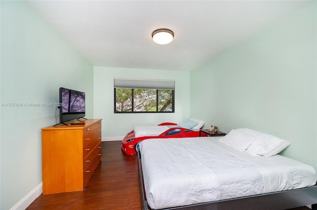 bedroom with dark hardwood / wood-style floors