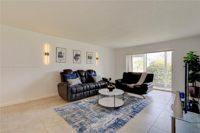 living room featuring a textured ceiling and light tile patterned flooring