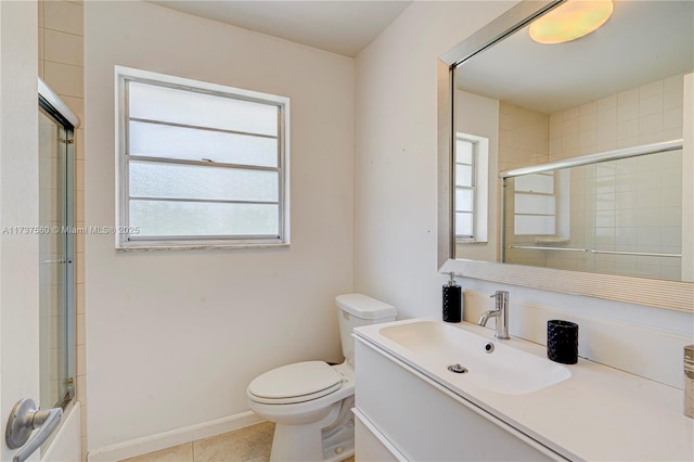 full bathroom featuring vanity, combined bath / shower with glass door, tile patterned floors, and toilet